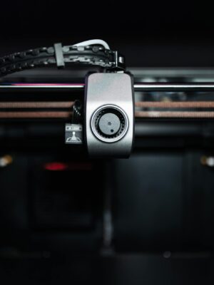 Detailed view of a 3D printer component in operation, showcasing technology and precision.