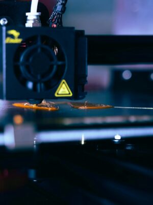 Detailed view of a 3D printer head during operation, showcasing modern printing technology.