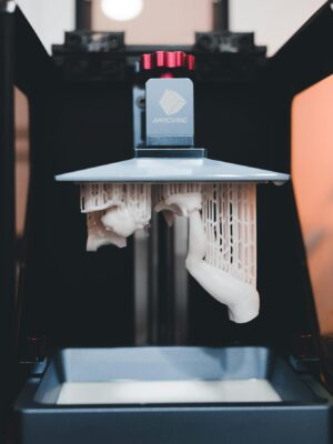 High-quality close-up of a 3D printer printing an object with resin.